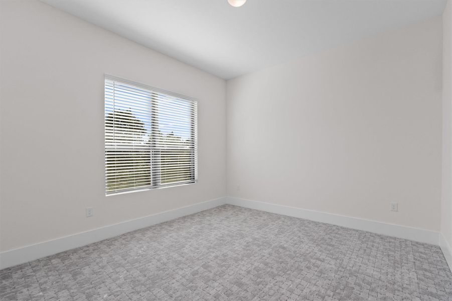 Empty room featuring baseboards and carpet flooring Empty room featuring baseboards and carpet flooring