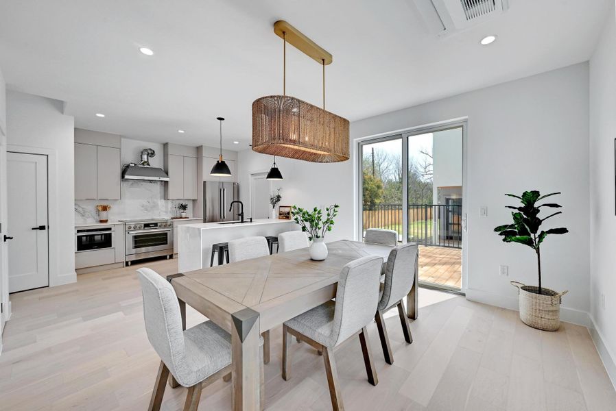 Dining area with recessed lighting and light wood-style flooring