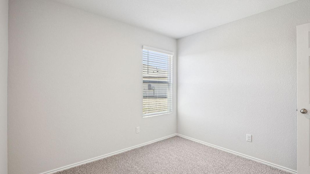 Carpeted room with a single window featuring horizontal blinds Carpeted room with a single window featuring horizontal blinds