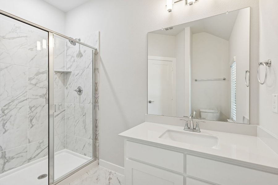 Bathroom in the Masters home plan by Trophy Signature Homes – REPRESENTATIVE PHOTO