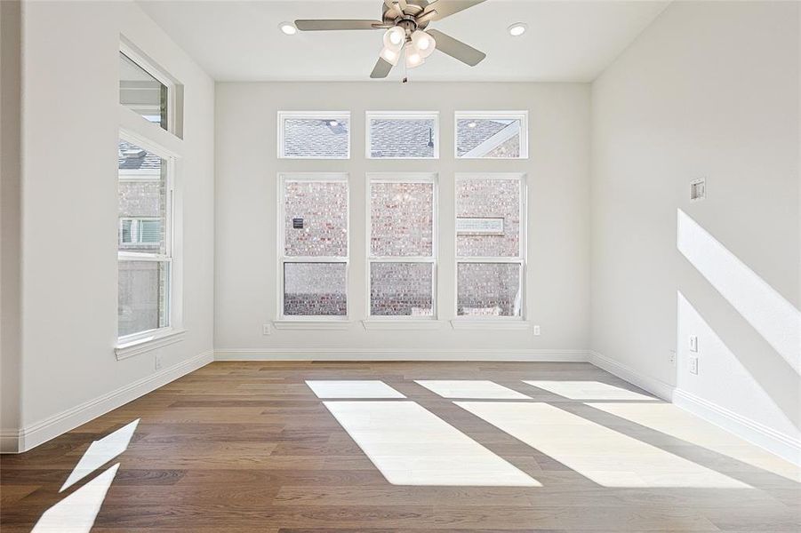 Unfurnished room with ceiling fan and light hardwood / wood-style flooring