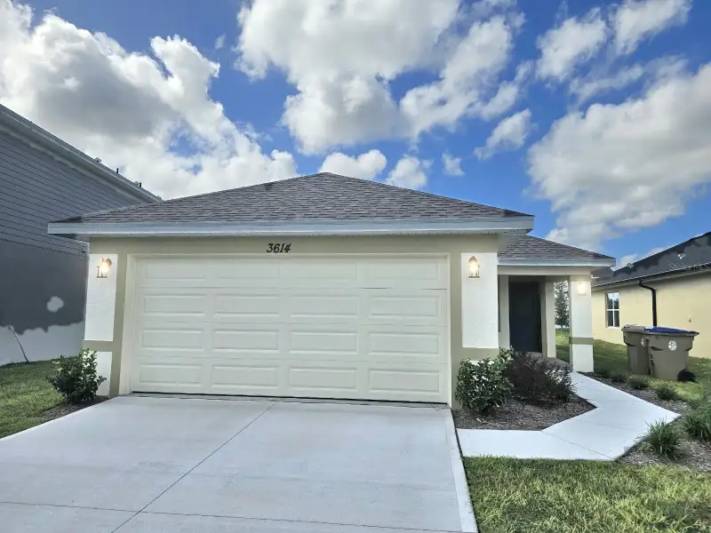 Front exterior of a new home in Harmony Central, St. Cloud, FL, highlighting curb appeal (Image 1). Front exterior of a new home in Harmony Central, St. Cloud, FL, highlighting curb appeal (Image 1).