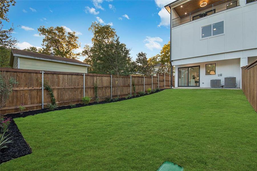 Fenced backyard with a patio area