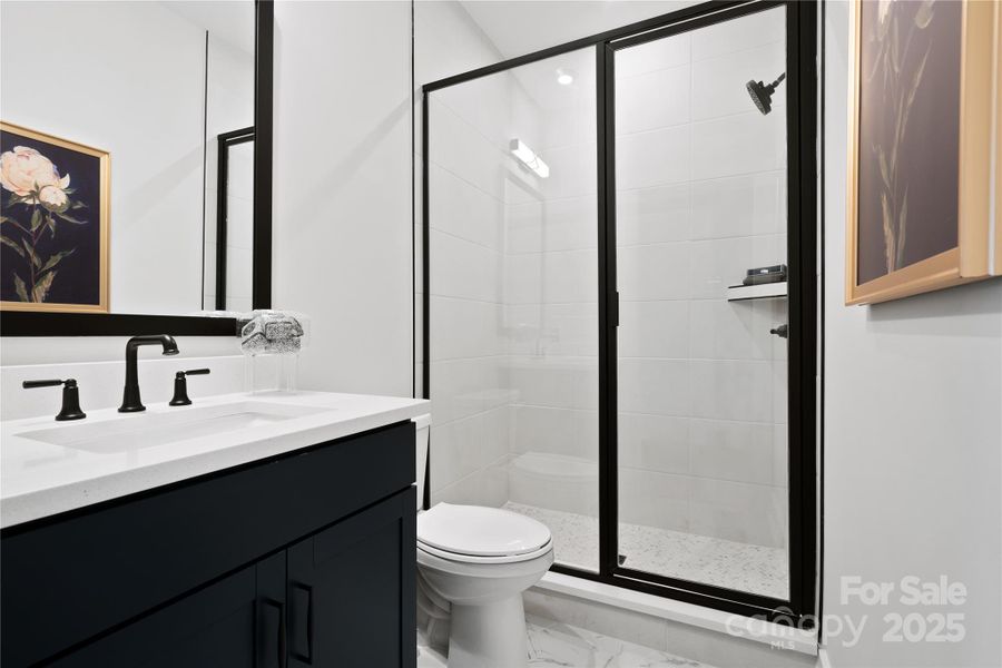 Upgraded guest bath on the first floor with walk-in shower and wall tile. *Model Photos | actual finishes, structural selections, and orientation may vary.