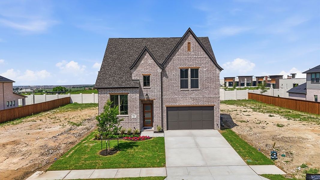 Front exterior of a new home in Hillside Village, Celina, TX, highlighting curb appeal (Image 2). Front exterior of a new home in Hillside Village, Celina, TX, highlighting curb appeal (Image 2).