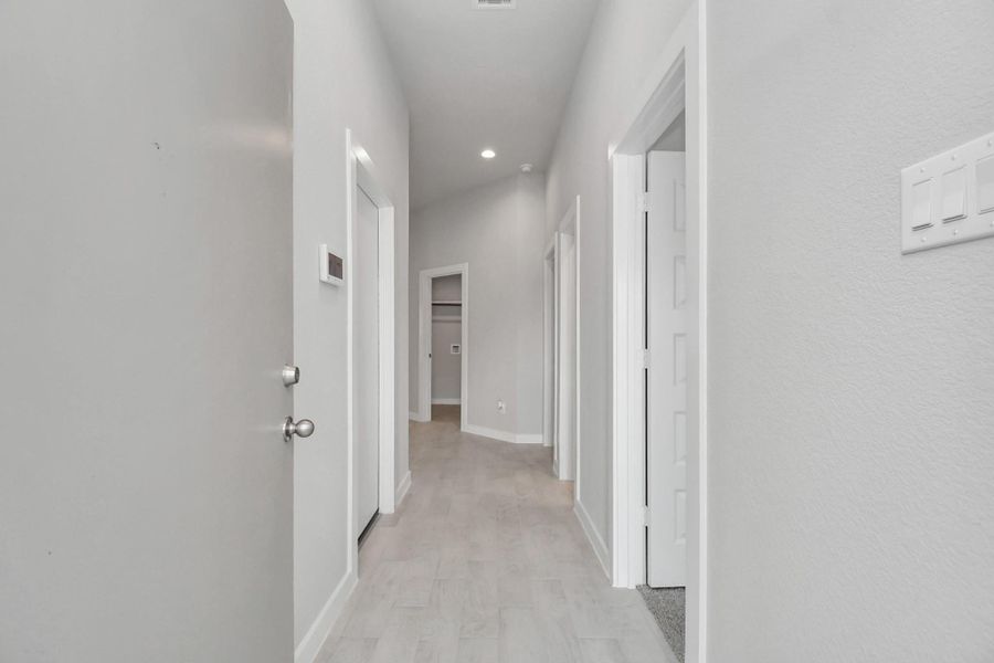 As you step into the threshold of this luxurious home, you'll soon be welcomed by an elegant glass door (to be installed). Inside, soaring ceilings amplify the spaciousness, while the refined wood-look tile flooring and oversized baseboards exude sophistication and charm.
