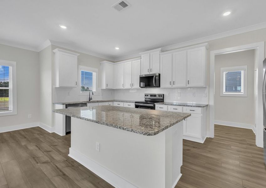 The kitchen has a spacious kitchen island.