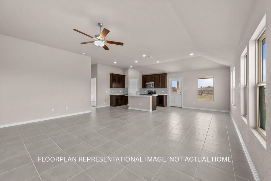 An open-concept living space with a contemporary kitchen and abundant natural light.