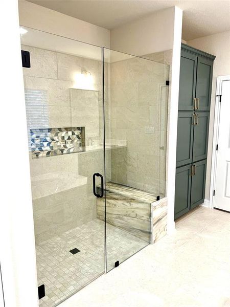 Full bath with a shower stall and tile patterned floors Full bath with a shower stall and tile patterned floors