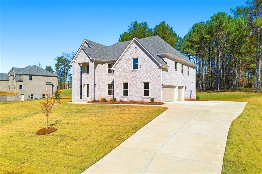 Front exterior of a new home in Underwood Crossing, Covington, GA, highlighting curb appeal (Image 1). Front exterior of a new home in Underwood Crossing, Covington, GA, highlighting curb appeal (Image 1).