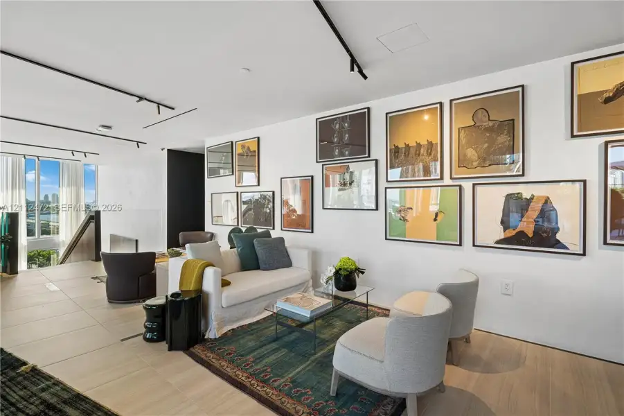 Large-format ceramic floor tiling, extensive floor-to-ceiling windows, and recessed track lighting