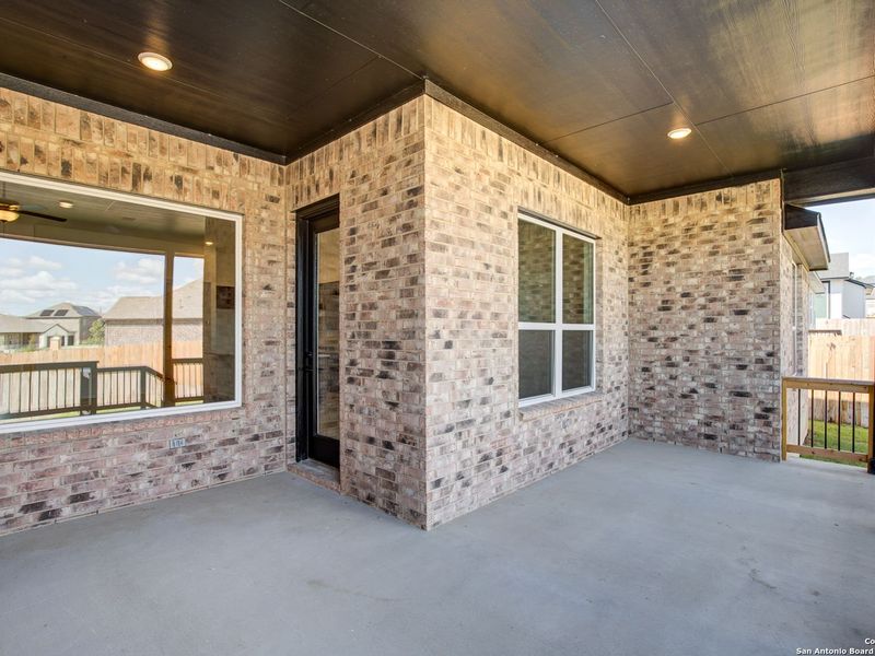 Exterior details and patio area of a home in The Reserve at Potranco Oaks, Castroville (Image 25).
