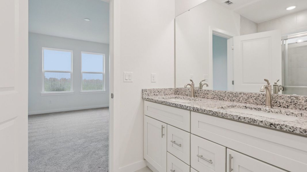 Primary Suite Bath with Dual Sinks in the Naples Floor Plan by DRB Homes Primary Suite Bath with Dual Sinks in the Naples Floor Plan by DRB Homes