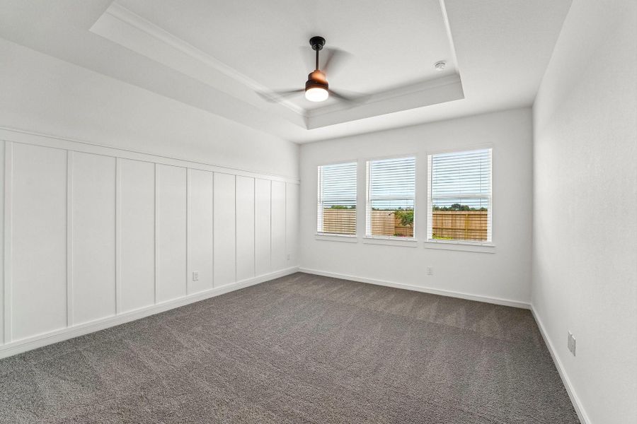 Spacious primary suite with decorative feature wall Spacious primary suite with decorative feature wall