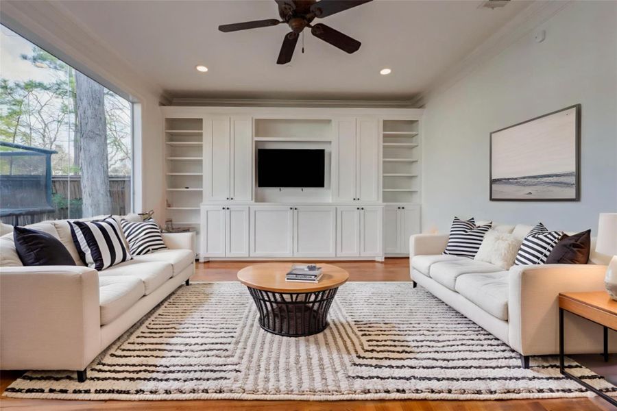 VIRTUALLY STAGED DECOR PHOTO - DOWNSTAIRS GAME ROOM, DOOR TO BACKYARD VERANDA.