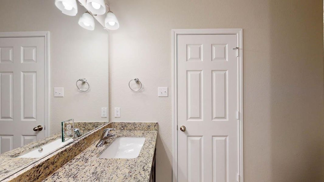 Bathroom with vanity and a chandelier