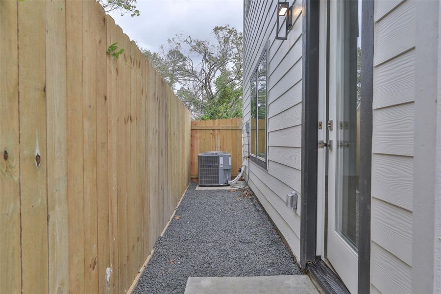 Low-maintenance backyard with a durable concrete slab and sleek bull rock design.