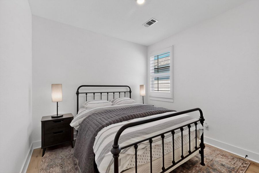 Bedroom  #3with wood finished floors and recessed lighting