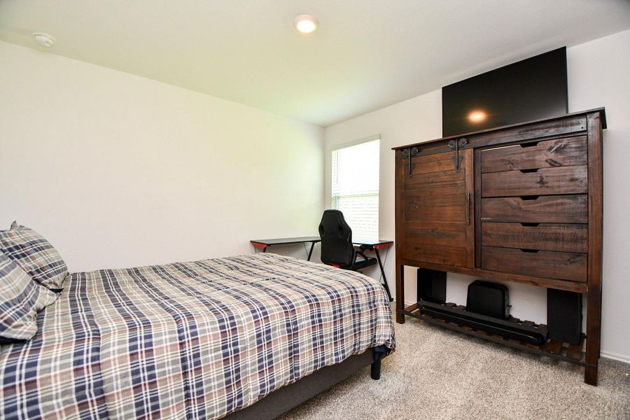 These secondary bedrooms have neutral walls and plush carpet