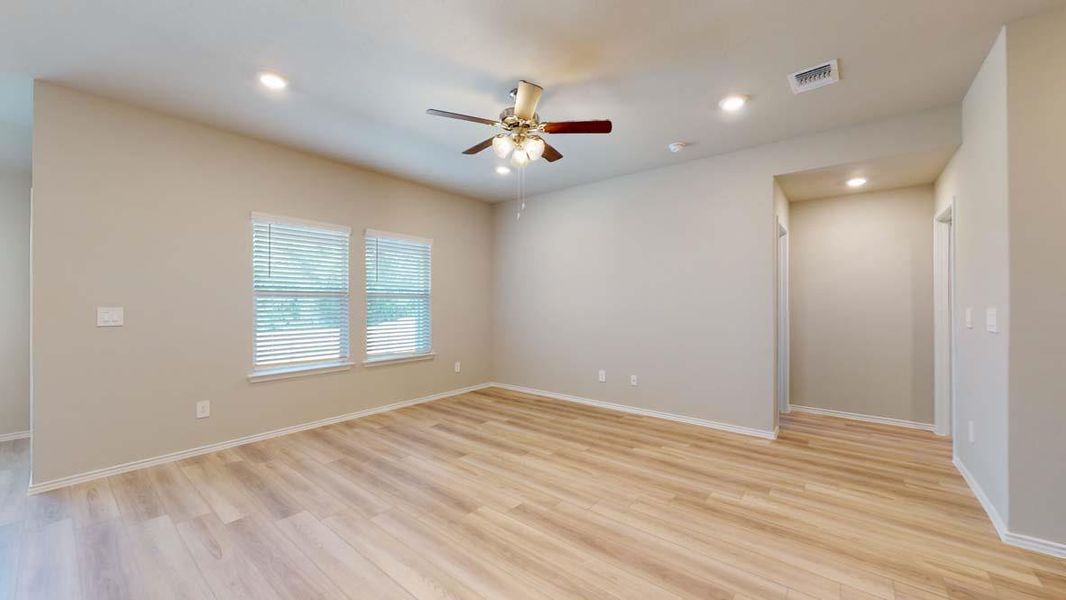 Spacious interior featuring wide-plank wood-finish flooring, neutral wall tones, and recessed lighting