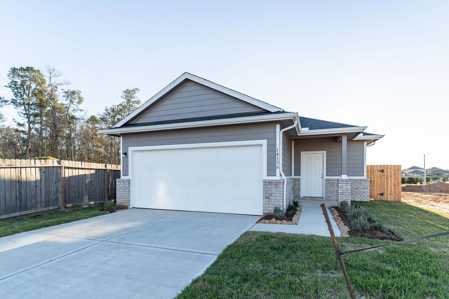 Front exterior of a new home in Caney Mills, Conroe, TX, highlighting curb appeal (Image 18).