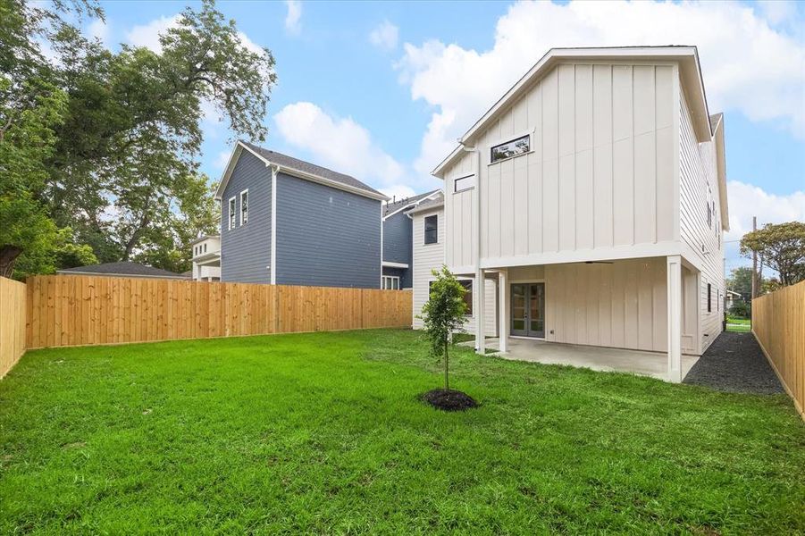 HUGE backyard with a covered porch with plumbing, electrical and gas pre-installed for a future outdoor kitchen. The home is also fitted with a sprinkler system and gutters.