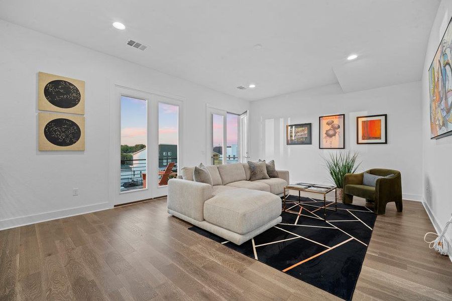 Living room featuring wood finished floors and recessed lighting
