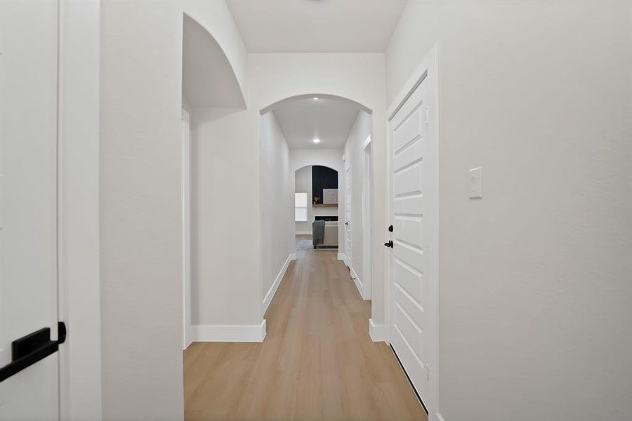 Corridor with light wood finished floors and arched walkways Corridor with light wood finished floors and arched walkways