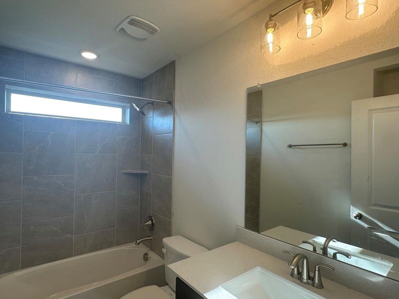 Bathroom featuring vanity and shower / washtub combination Bathroom featuring vanity and shower / washtub combination