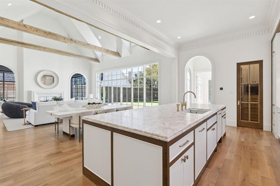 Kitchen featuring white cabinetry, open floor plan, a center island with sink, plenty of natural light, and recessed lighting