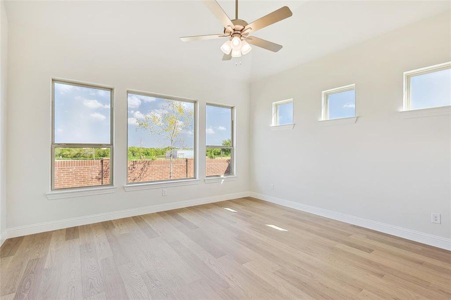 Unfurnished room featuring ceiling fan and light hardwood / wood-style flooring