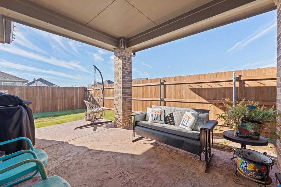 Fenced backyard with a patio area and an outdoor living space