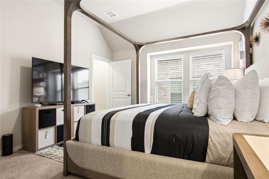 Bedroom with carpet and lofted ceiling