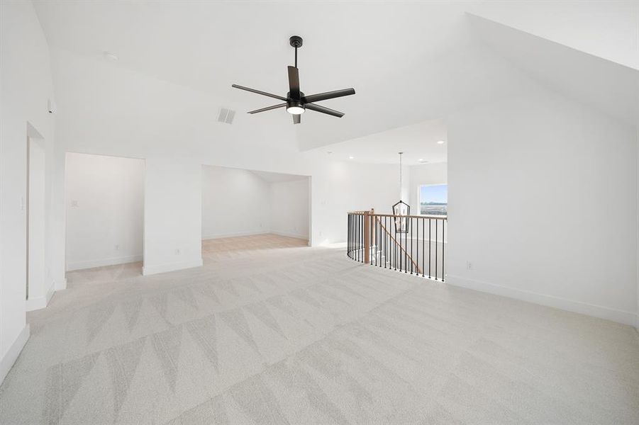 Additional living space with light carpet, high vaulted ceiling, recessed lighting, and a ceiling fan