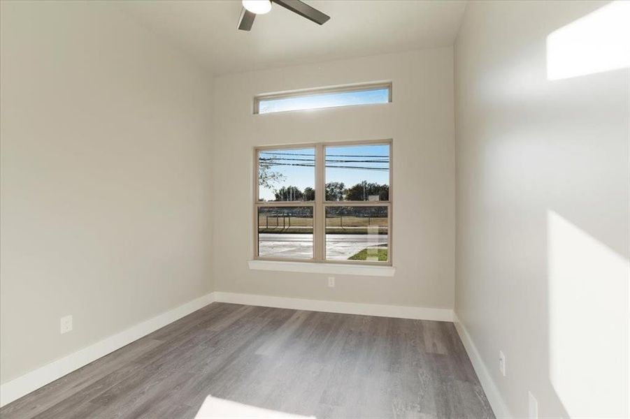 Empty room featuring hardwood / wood-style floors and ceiling fan