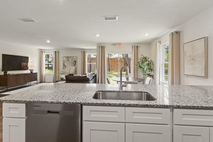 A large kitchen with marble counters.
