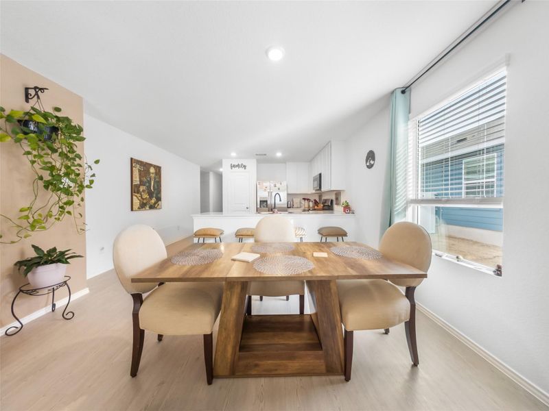 Dining area with light wood-type flooring and recessed lighting