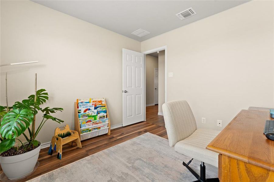 Home office with baseboards and dark wood-type flooring