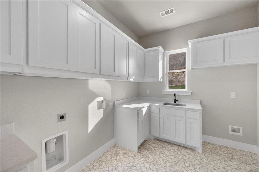 Laundry room featuring sink