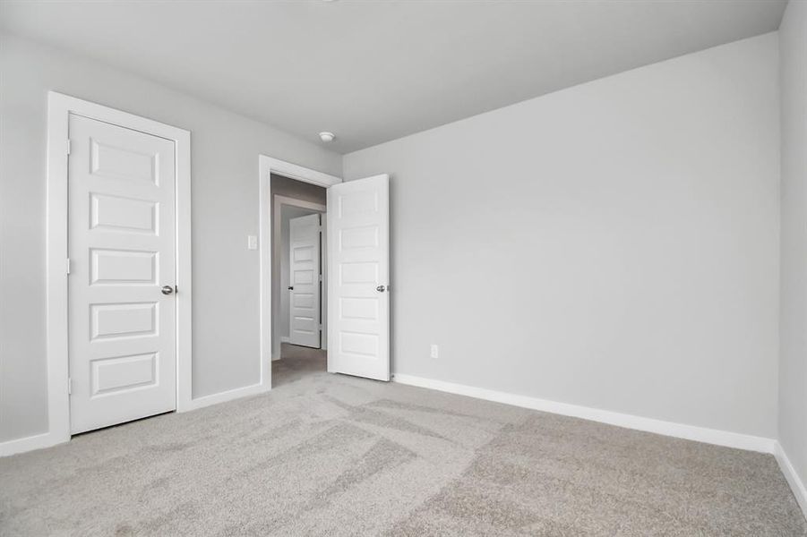 Generously sized secondary bedrooms featuring spacious closets, soft and inviting carpeting underfoot, large windows allowing plenty of natural light, and the added touch of privacy blinds for your personal retreat.