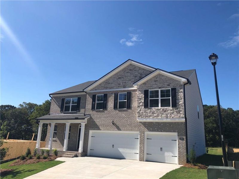 Front exterior of a new home in , Dacula, GA, highlighting curb appeal (Image 2).