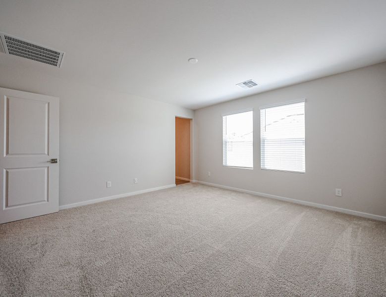 A room with a carpet and a door.