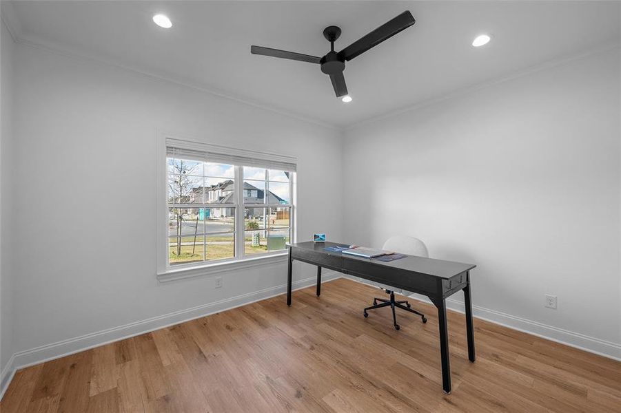 Office with light wood finished floors, ornamental molding, a ceiling fan, and recessed lighting Office with light wood finished floors, ornamental molding, a ceiling fan, and recessed lighting
