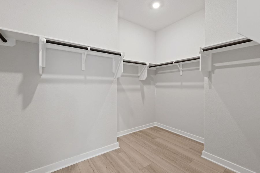 Walk-in closet in Primary Bedroom Walk-in closet in Primary Bedroom