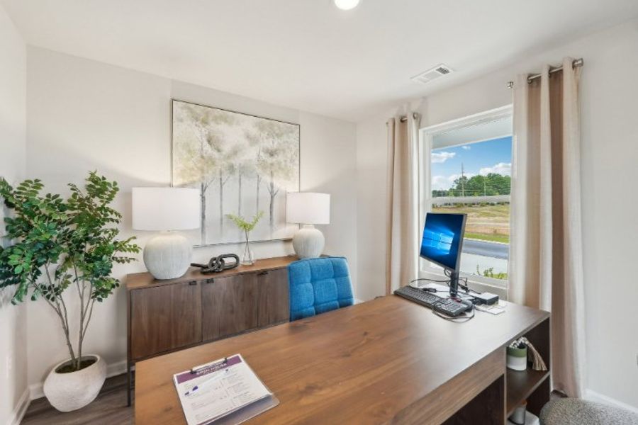 A room with a desk and a computer.