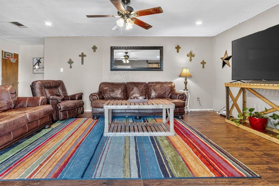 Living area with wood finished floors, recessed lighting, and ceiling fan Living area with wood finished floors, recessed lighting, and ceiling fan