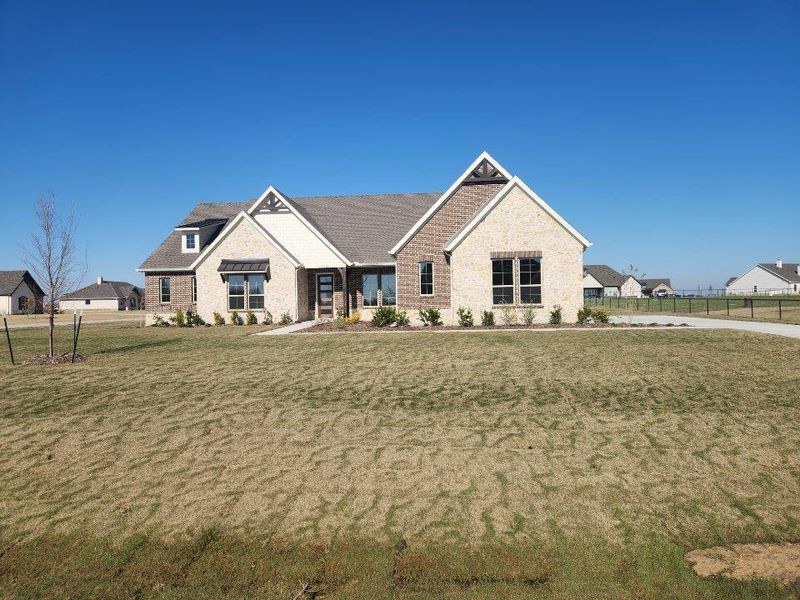 Front exterior of a new home in Rocky Top, Krum, TX, highlighting curb appeal (Image 2).