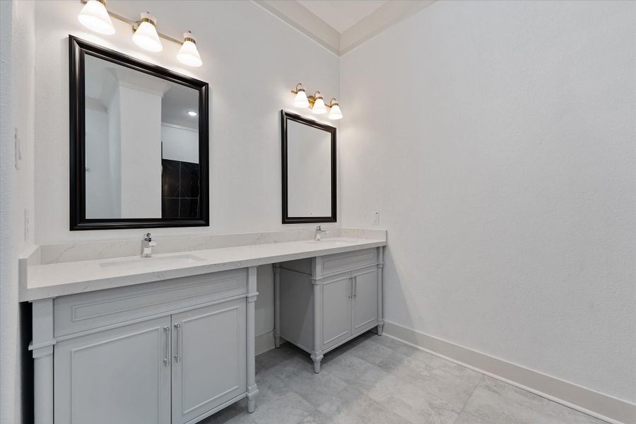 This primary bathroom view shows two separate sink areas. This primary bathroom view shows two separate sink areas.