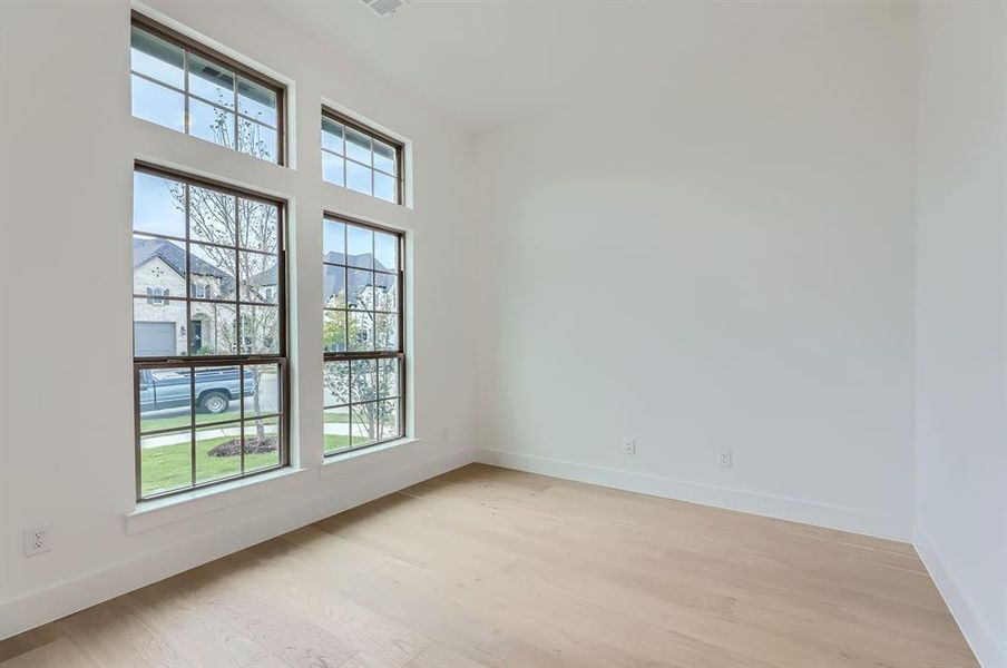 Spare room featuring plenty of natural light and light wood-type flooring