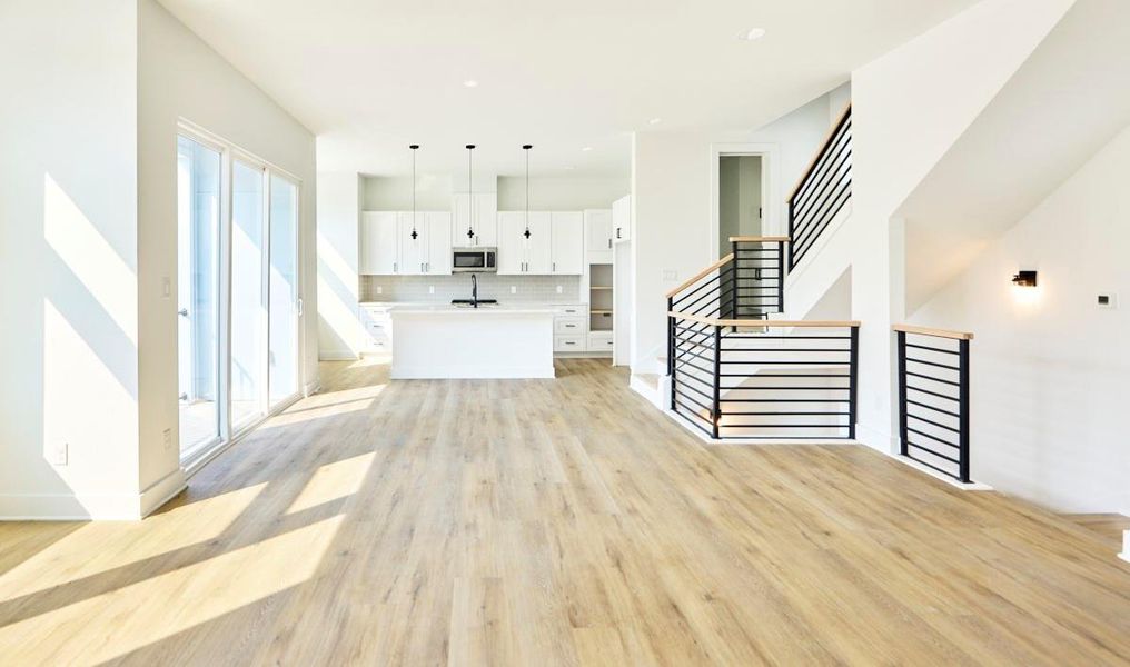 Bright and spacious, this open-concept living, dining, and kitchen area is perfect for entertaining. Featuring pristine quartz countertops, stainless steel appliances, and custom cabinetry, it’s a chef’s dream with plenty of space for hosting guests or enjoying family meals. Bright and spacious, this open-concept living, dining, and kitchen area is perfect for entertaining. Featuring pristine quartz countertops, stainless steel appliances, and custom cabinetry, it’s a chef’s dream with plenty of space for hosting guests or enjoying family meals.